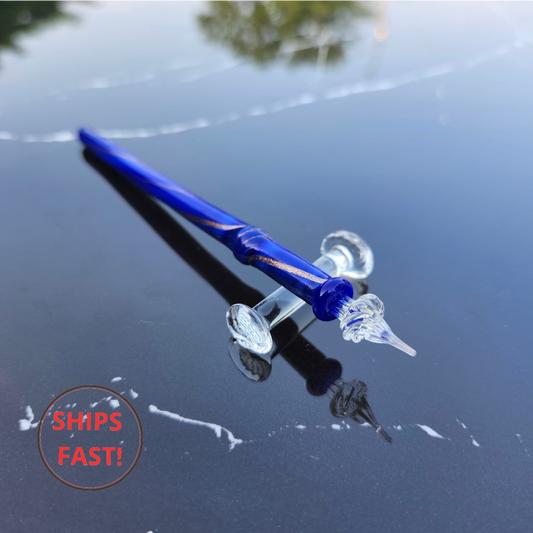 Elegant Mistral blue glass pen photographed with ink cleaning orb and luxury writing accessories