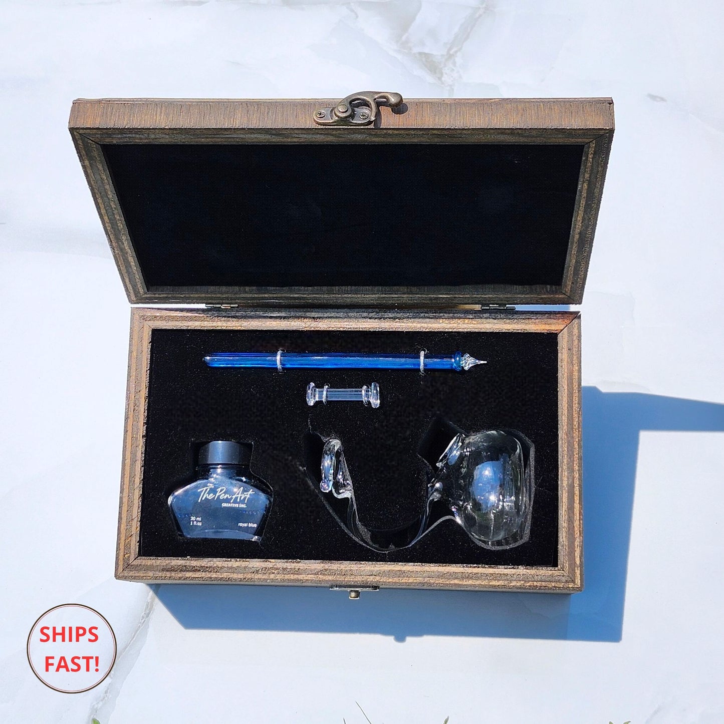 Artisan Cerulean blue pen photographed with ink bottle, orb, and minimalist desk setup