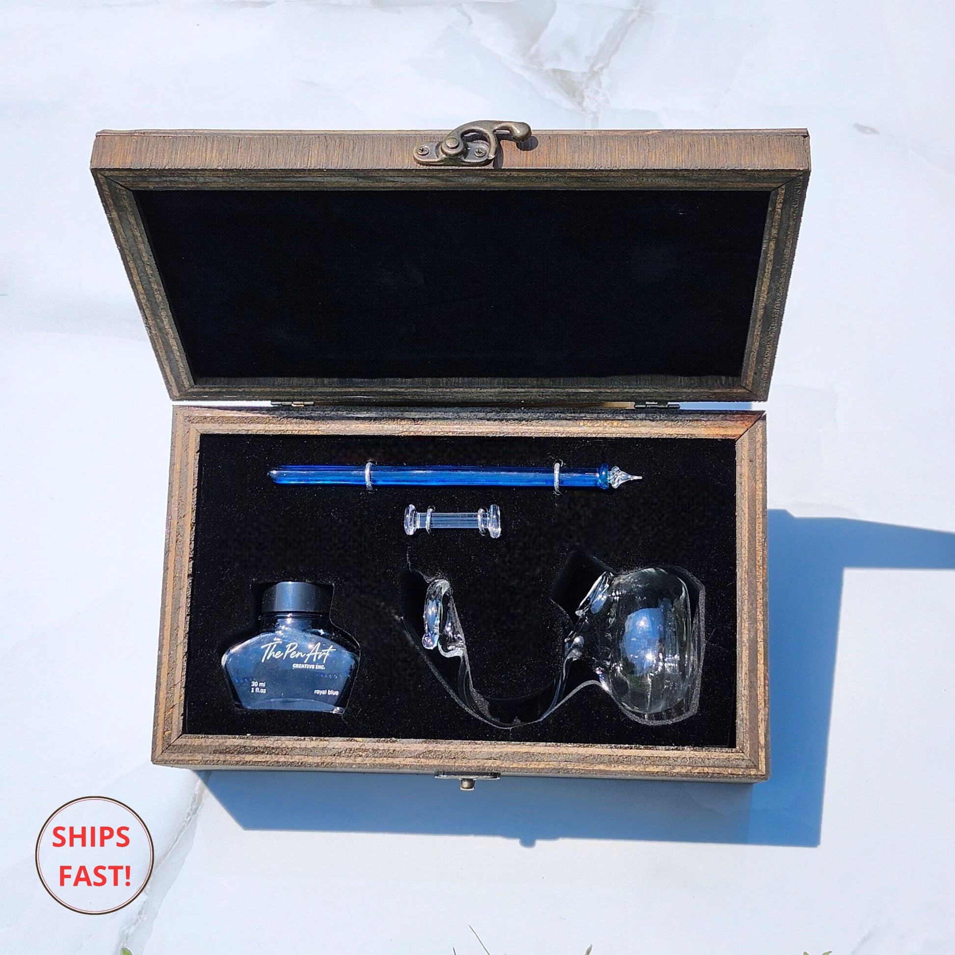 Artisan Cerulean blue pen photographed with ink bottle, orb, and minimalist desk setup