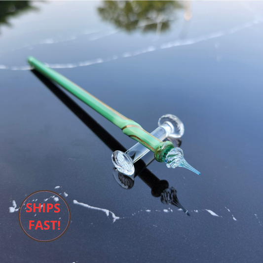 Elegant Everin anniversary pen photographed with ink cleaning orb and writing accessories