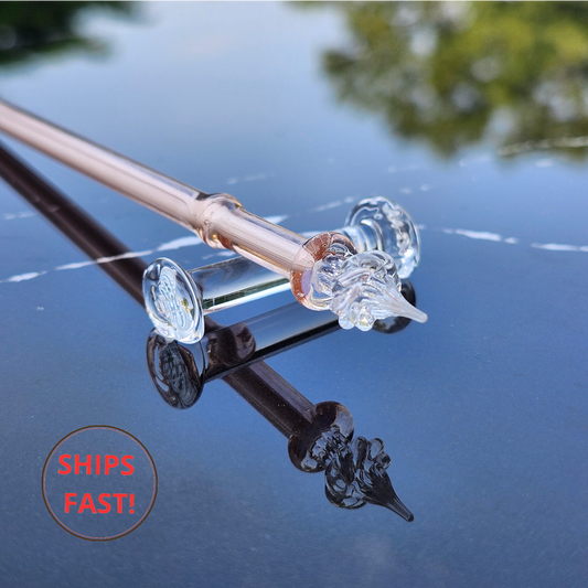 Inspirational pink glass dip pen photographed with ink cleaning orb and writing accessories