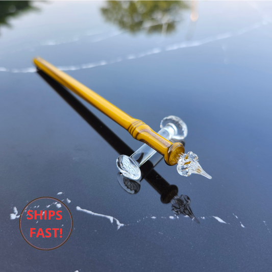 Rare collectible Oriel glass pen photographed with ink cleaning orb, ink bottle, and pen rest