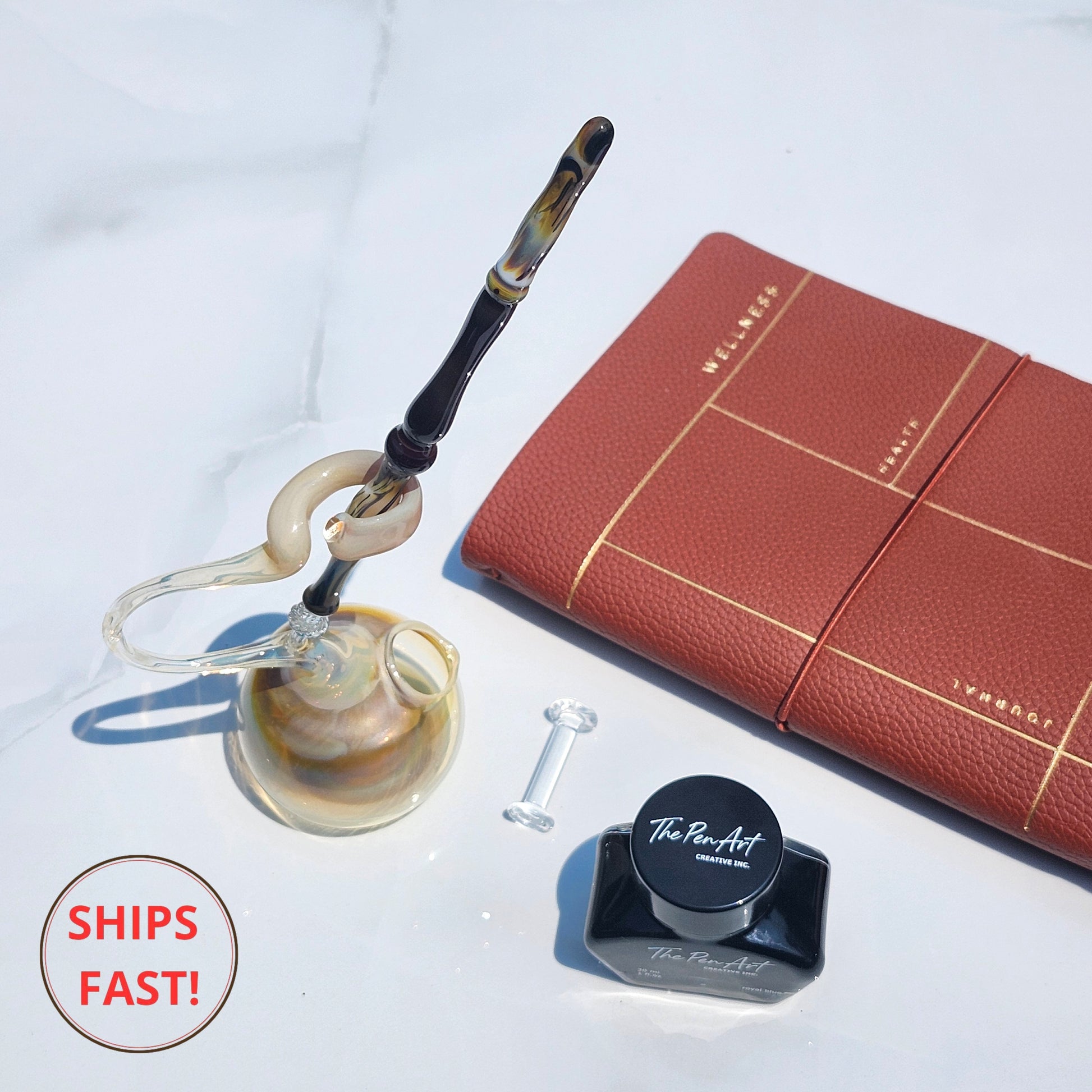Golden-swirl Solaris glass pen in luxury set, ideal for wedding, retirement, or celebration gifting.