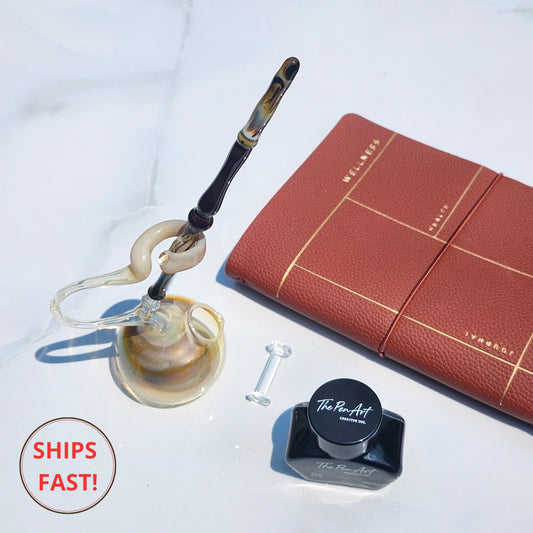 Golden-swirl Solaris glass pen in luxury set, ideal for wedding, retirement, or celebration gifting.