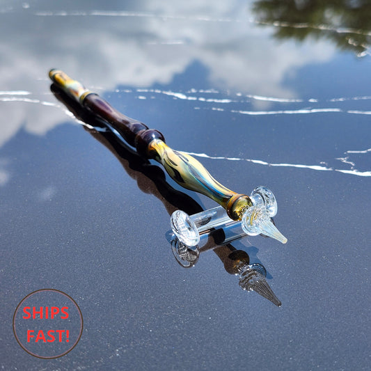 Solaris glass pen with swirling amber and deep blue hues on display